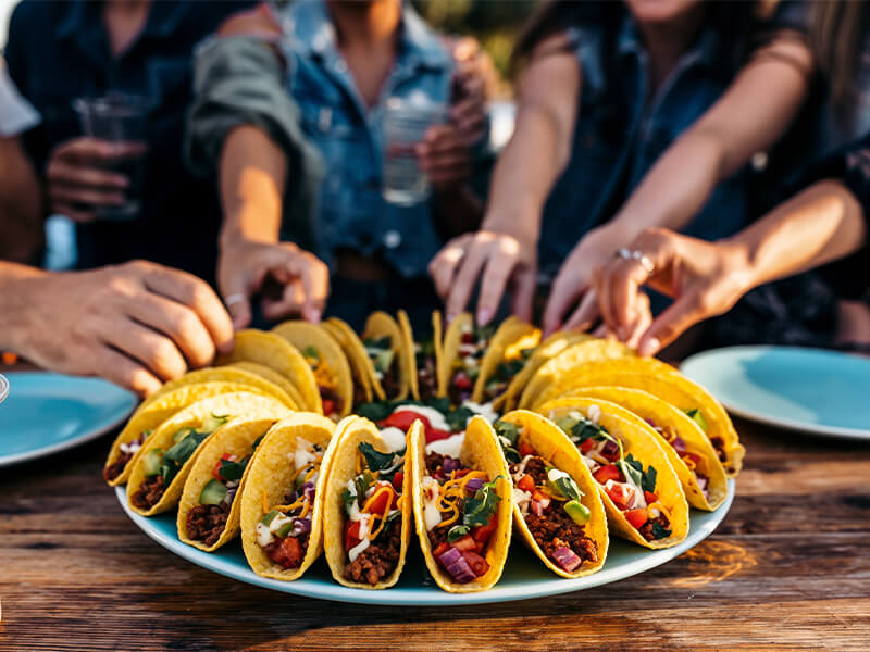 A picture of a lot of tacos on a plate.